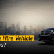 A sleek black private hire car parked on a city street with tall buildings in the background, showing comfort, style and reliability in professional minicab travel.